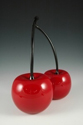 2 red cherries with black stems